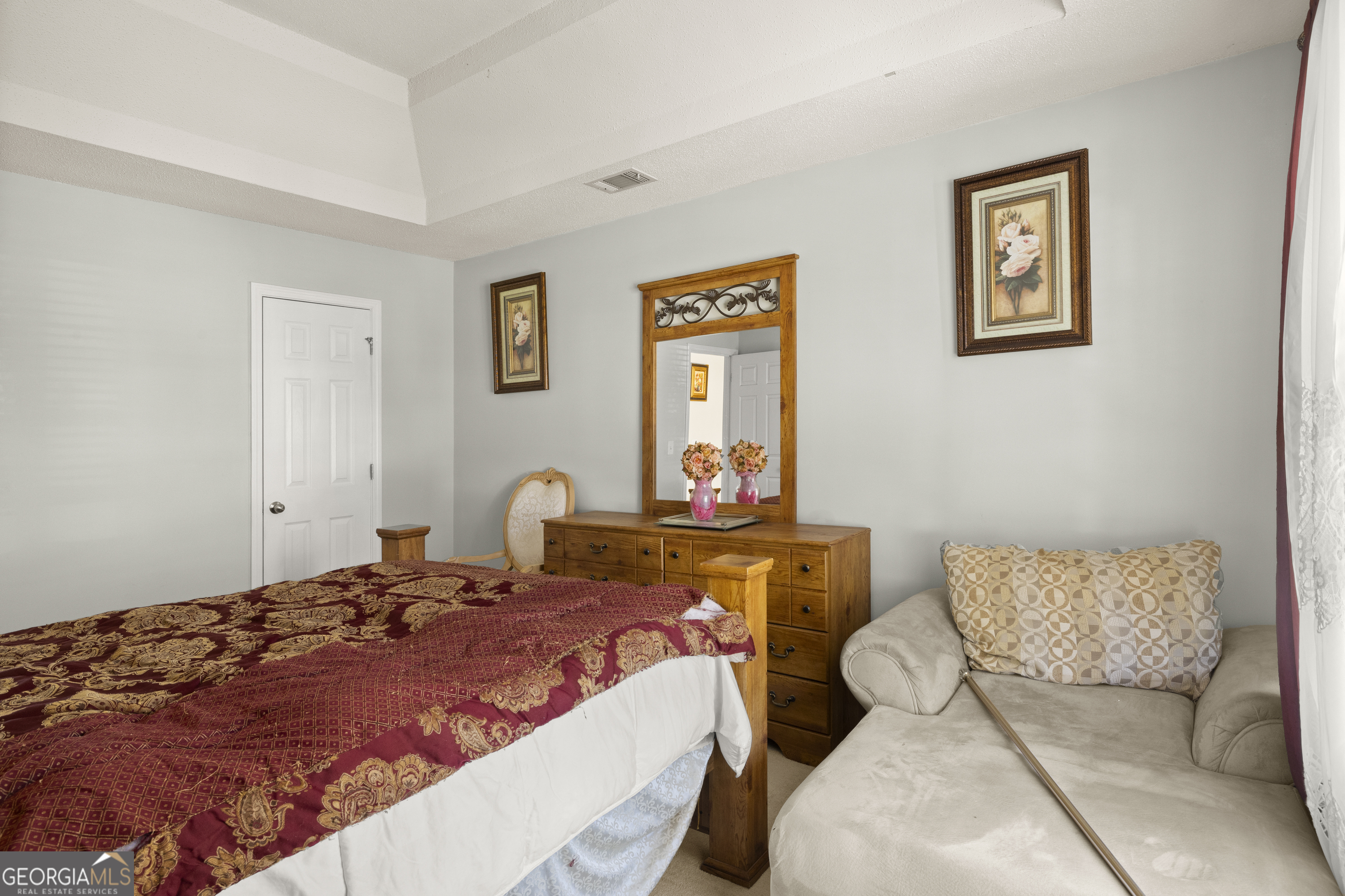 11961 Markham Way Hampton, GA 30228 - Photo 41 of 49 a bedroom with a bed and a couch