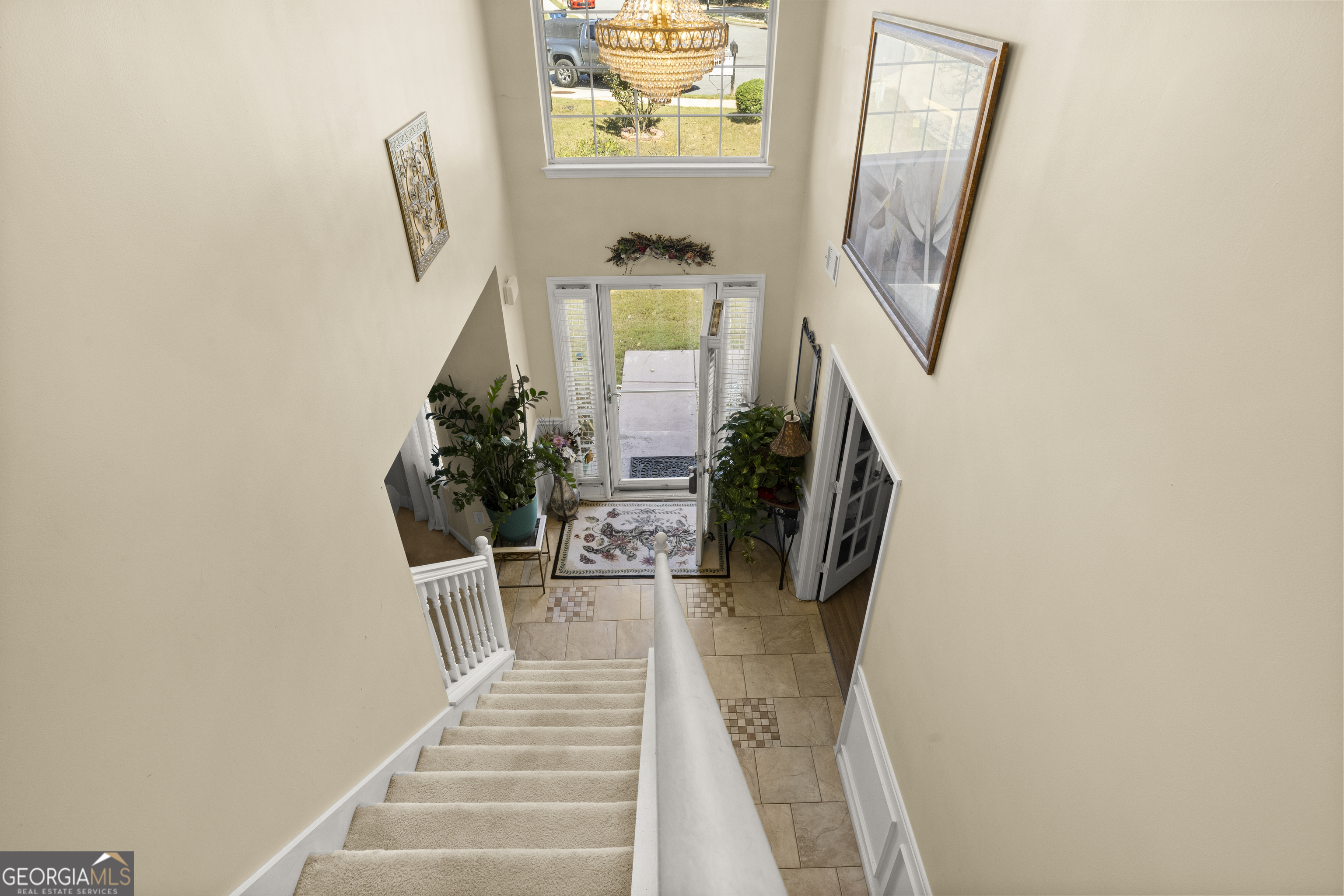 11961 Markham Way Hampton, GA 30228 - Photo 42 of 49 a hallway with wooden floor and a potted plant