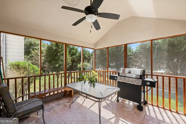 a balcony with furniture and a potted plant