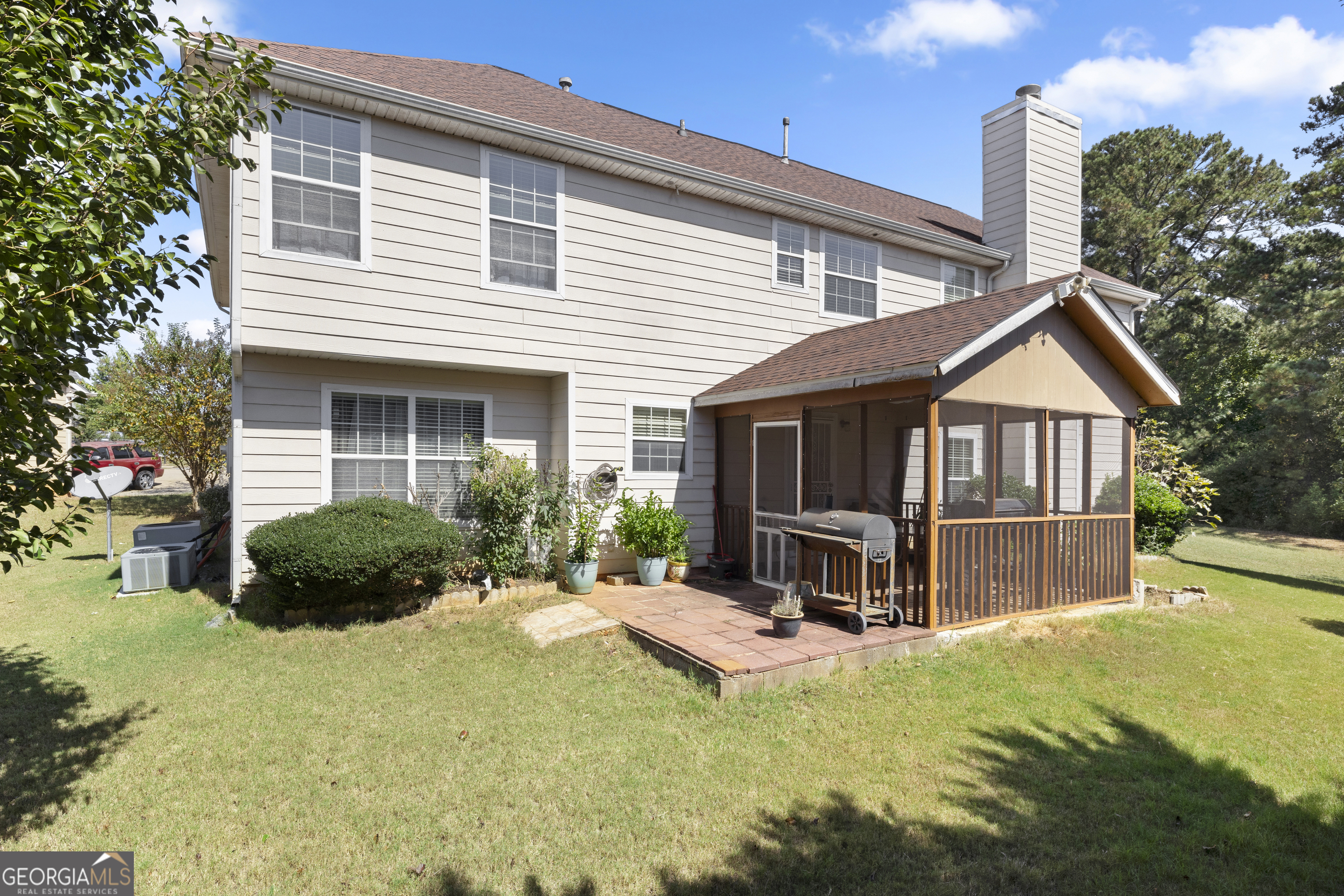 11961 Markham Way Hampton, GA 30228 - Photo 46 of 49 a view of a house with a flat patio and a yard