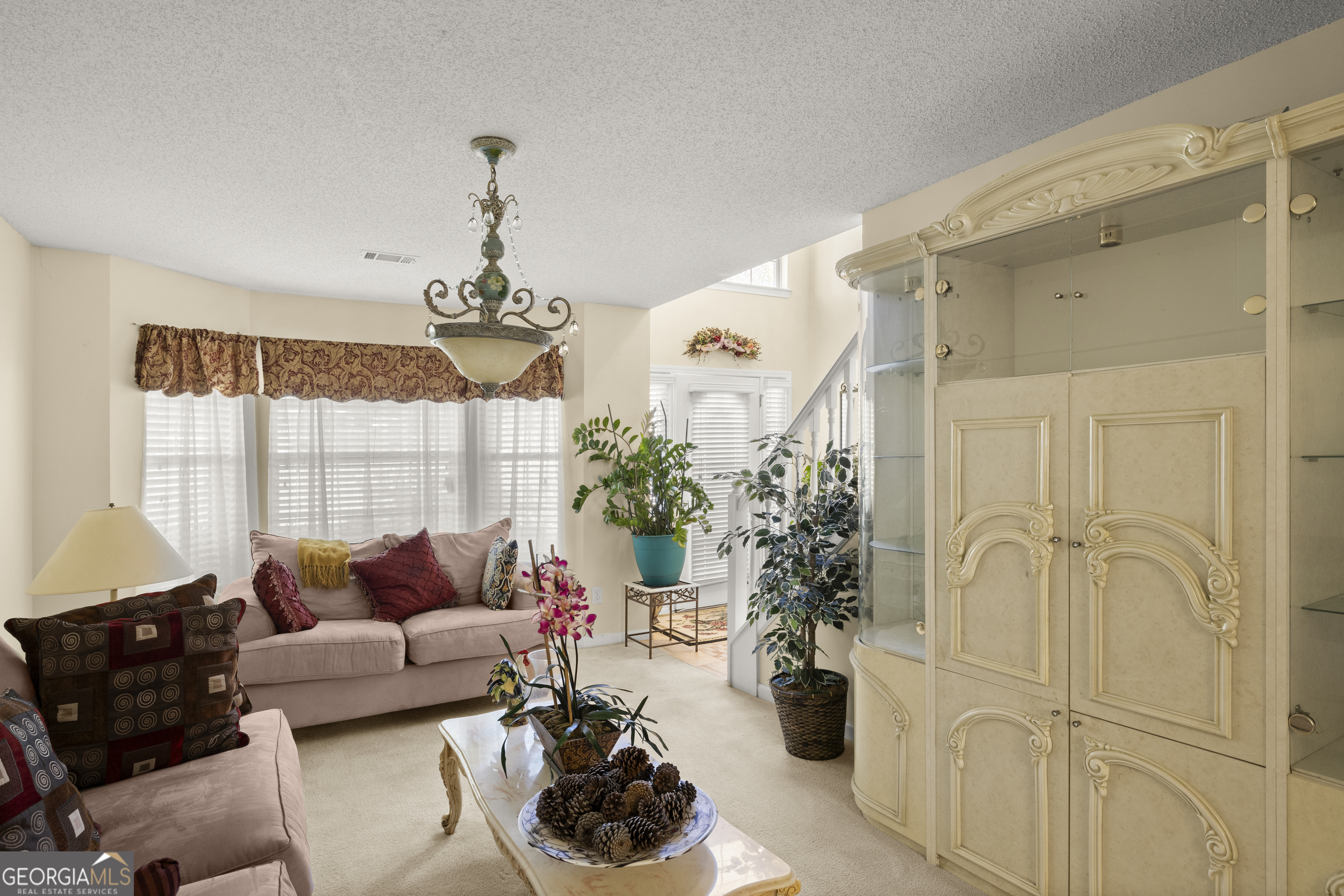 11961 Markham Way Hampton, GA 30228 - Photo 7 of 49 a living room with furniture and a chandelier