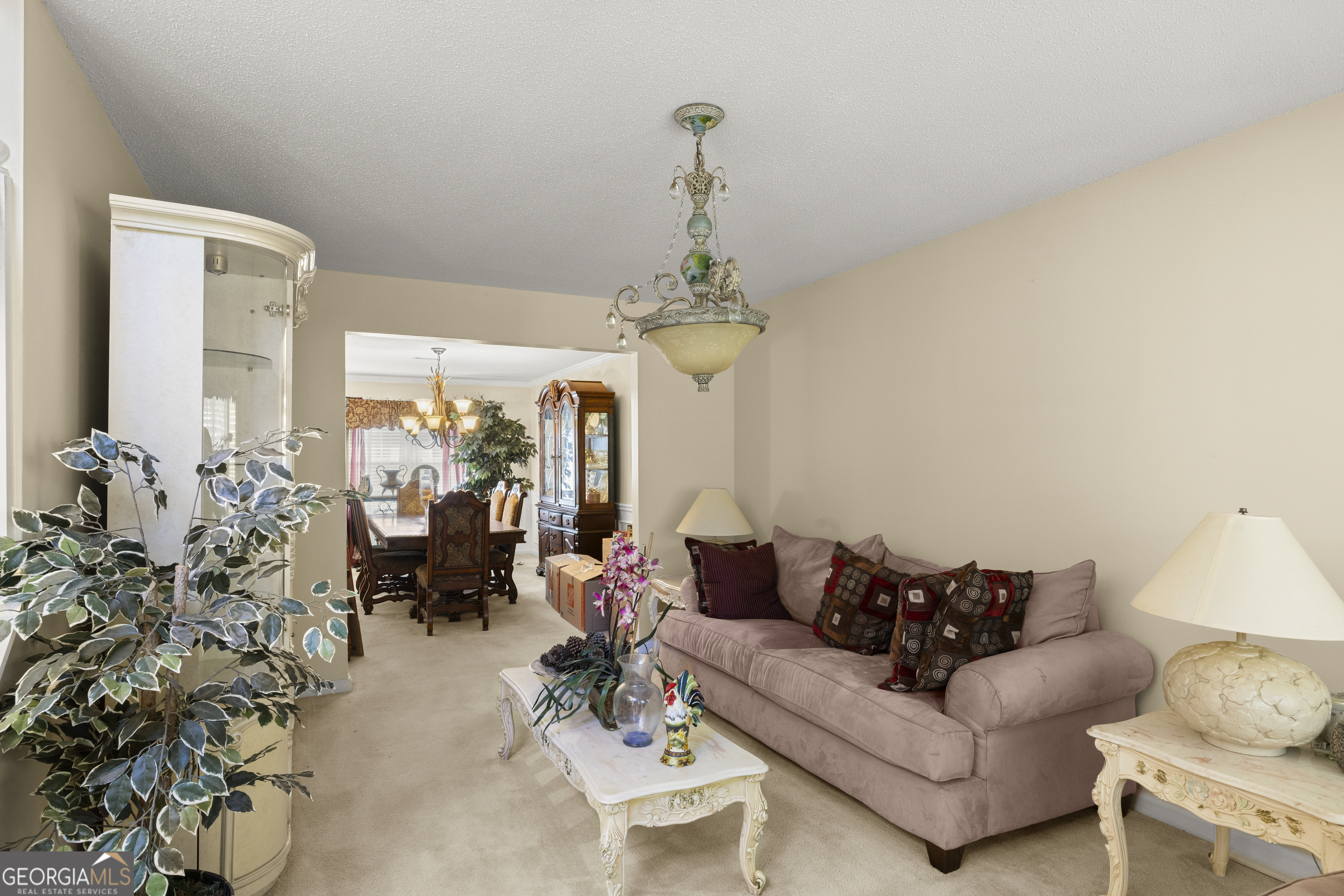 11961 Markham Way Hampton, GA 30228 - Photo 9 of 49 a living room with furniture a chandelier and a chandelier