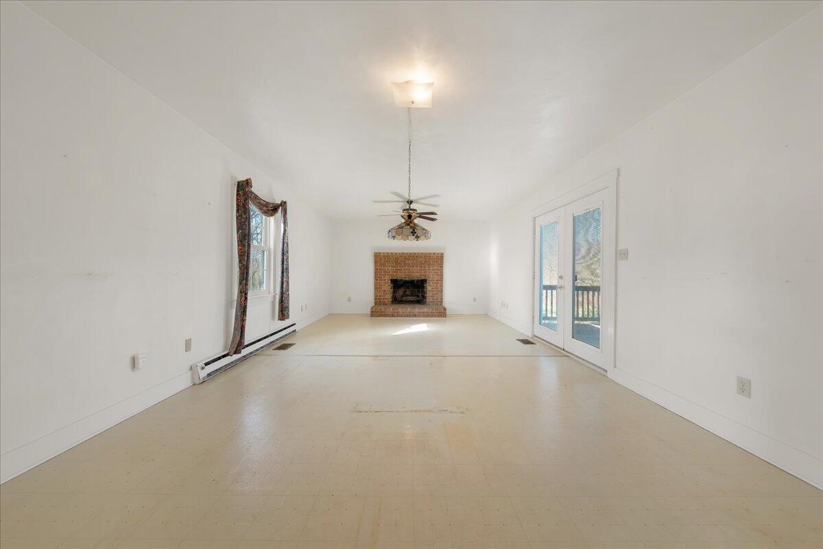 1391 Deep Woods Road Hardy, VA 24101 - Photo 21 of 43 a view of an empty room with a fireplace and a window