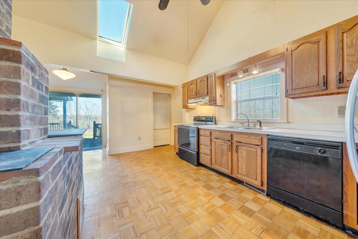 1391 Deep Woods Road Hardy, VA 24101 - Photo 29 of 43 a kitchen with stainless steel appliances granite countertop a stove a sink dishwasher and a refrigerator with wooden cabinets