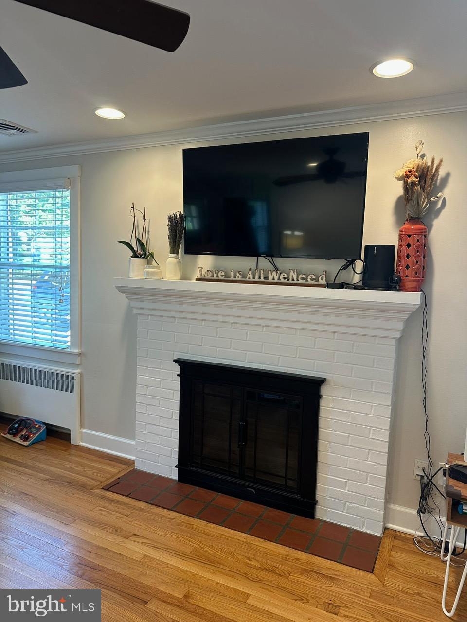 227 Dorset Road Devon, PA 19333 - Photo 14 of 30 a living room with a fireplace and wooden floor