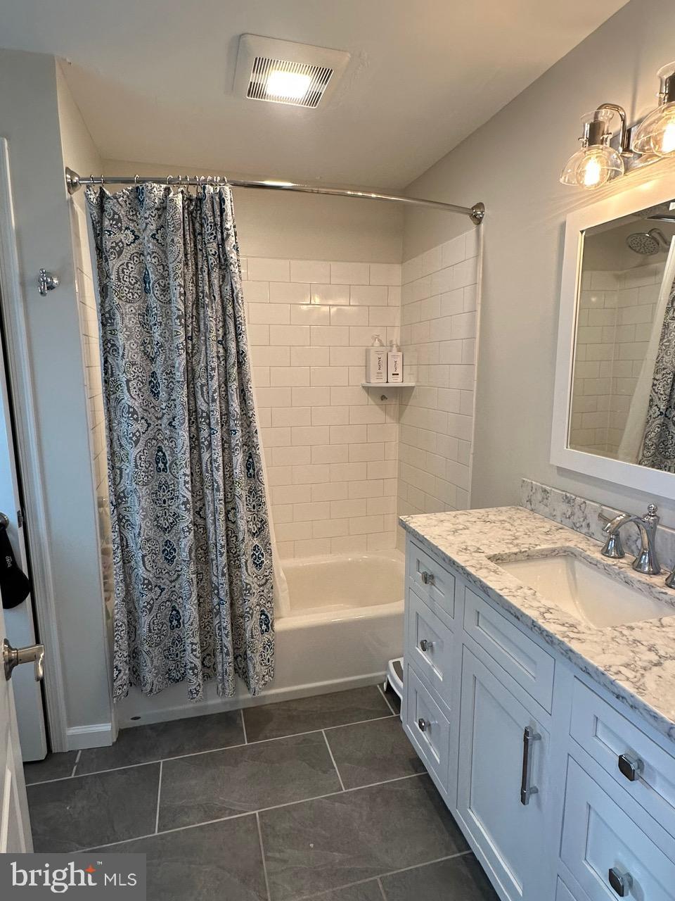 227 Dorset Road Devon, PA 19333 - Photo 19 of 30 a bathroom with a granite countertop sink a mirror a vanity and a shower