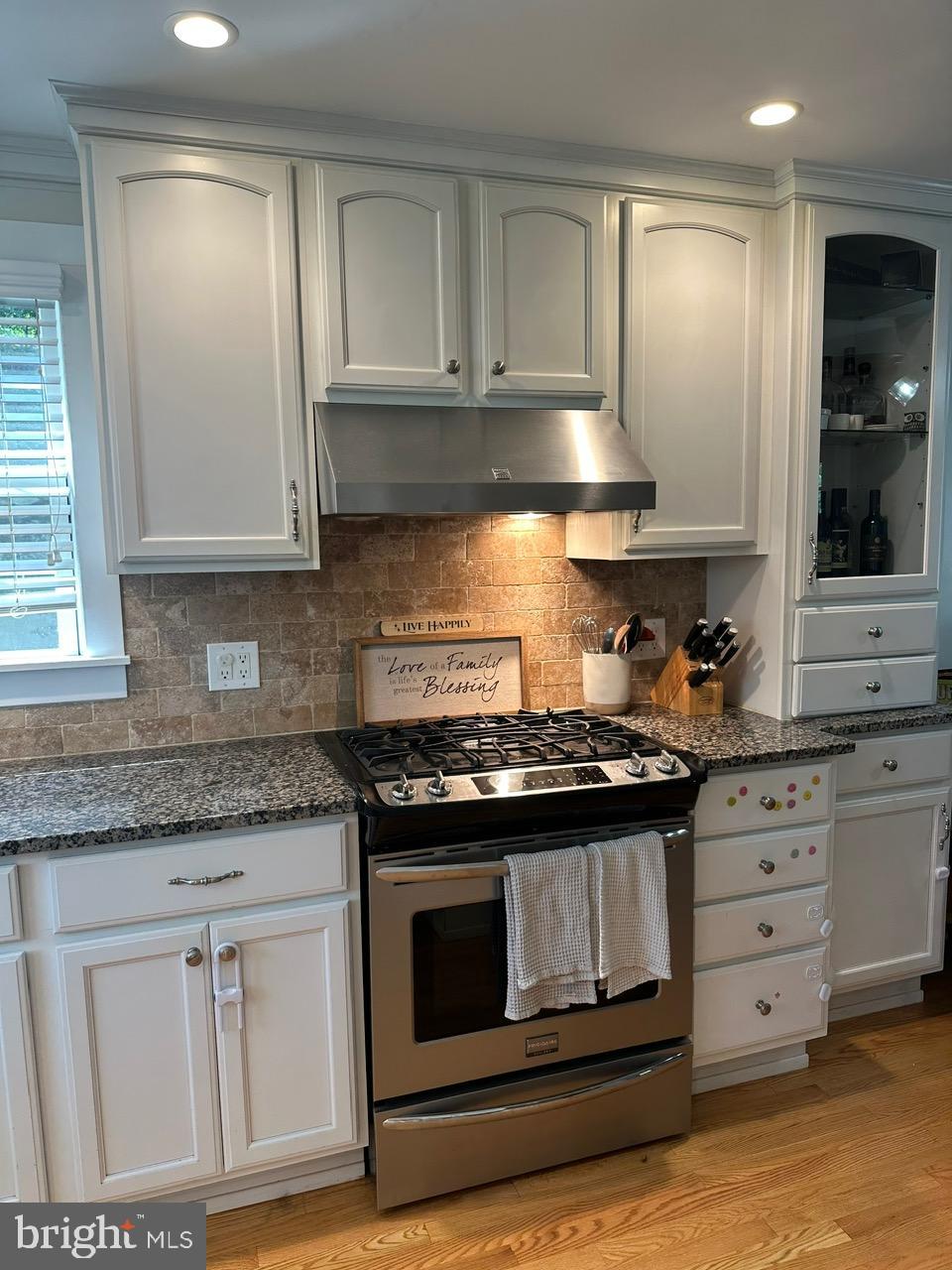 227 Dorset Road Devon, PA 19333 - Photo 7 of 30 a kitchen with granite countertop white cabinets and stainless steel appliances