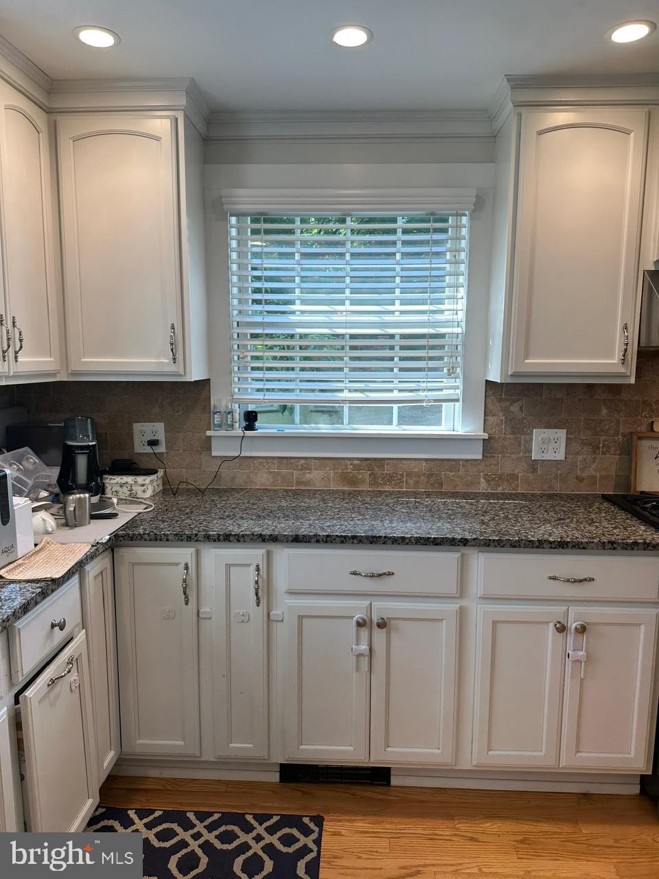 227 Dorset Road Devon, PA 19333 - Photo 9 of 30 a kitchen with granite countertop a sink and a white stove
