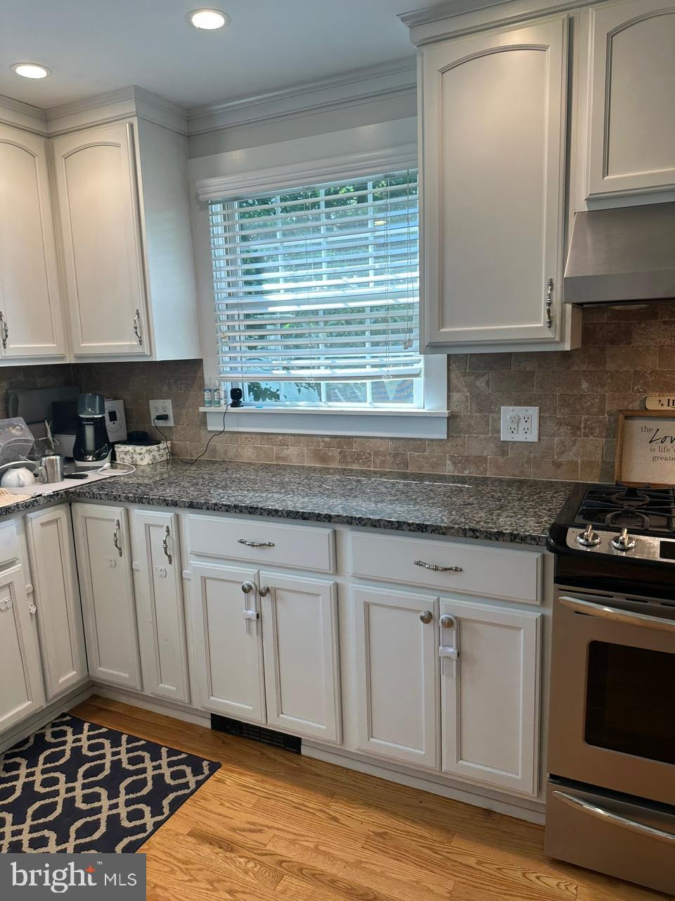 227 Dorset Road Devon, PA 19333 - Photo 10 of 30 a kitchen with granite countertop a stove a sink and a microwave