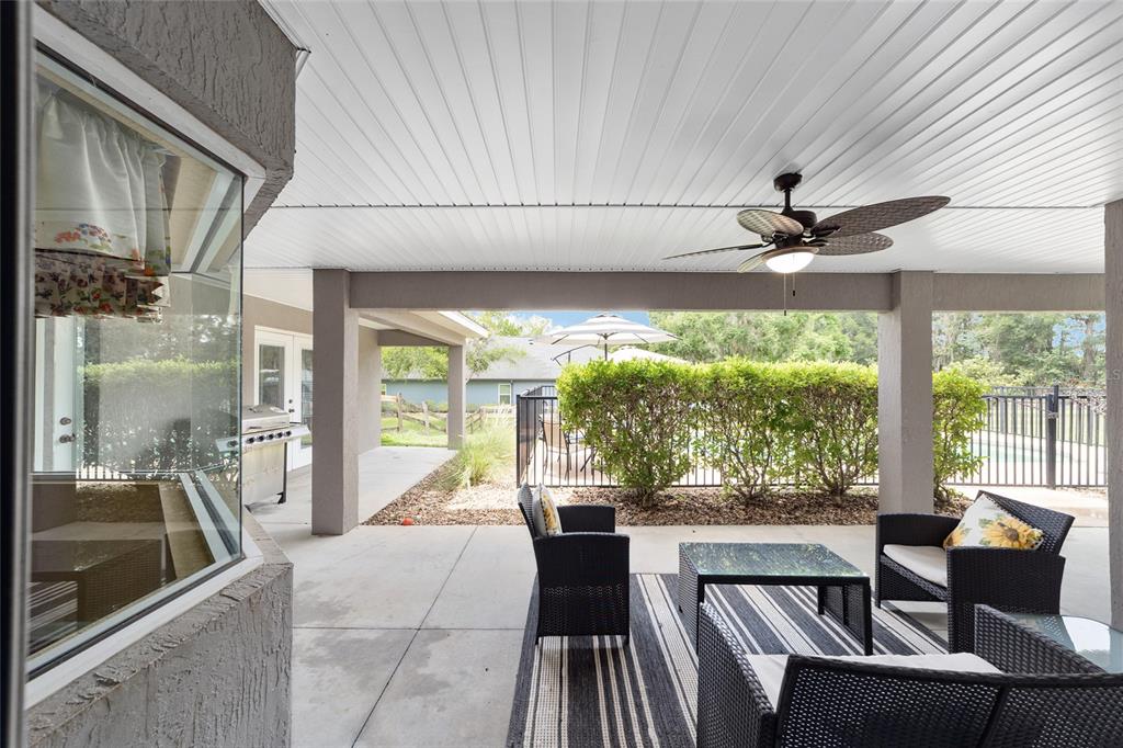 2151 Southeast 59th Street Ocala, FL 34480 - Photo 13 of 72 a living room with furniture and a floor to ceiling window