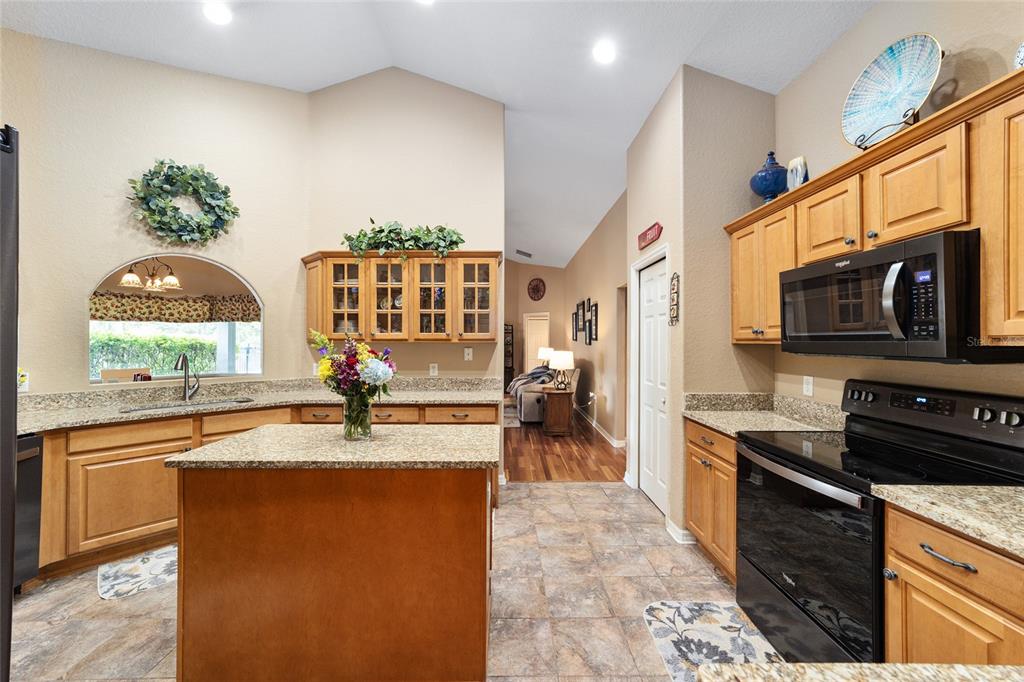 2151 Southeast 59th Street Ocala, FL 34480 - Photo 17 of 72 a kitchen with stainless steel appliances granite countertop a sink stove and cabinets