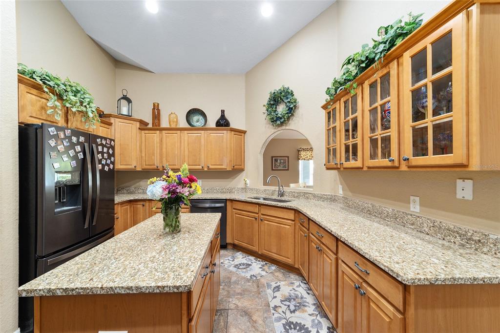 2151 Southeast 59th Street Ocala, FL 34480 - Photo 18 of 72 a kitchen with stainless steel appliances granite countertop a sink stove and cabinets
