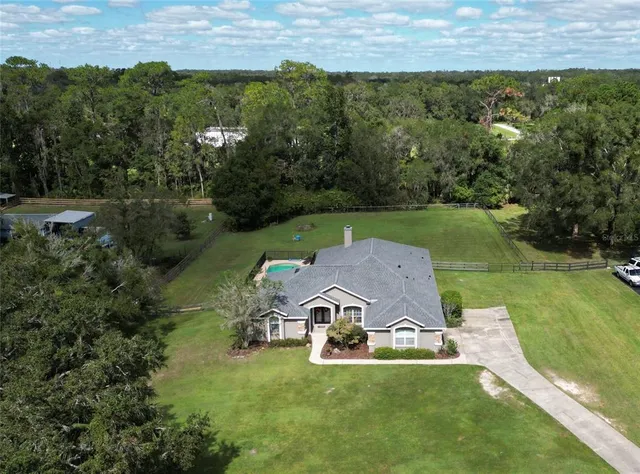 an aerial view of a house with a yard