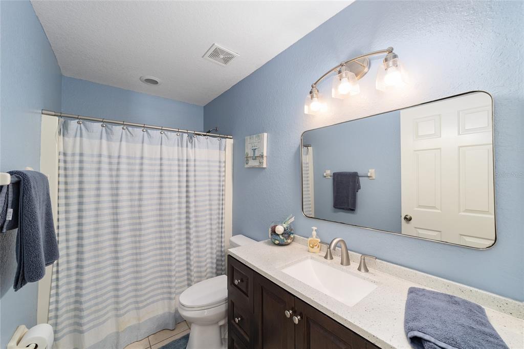 2151 Southeast 59th Street Ocala, FL 34480 - Photo 29 of 72 a bathroom with a sink a toilet and mirror