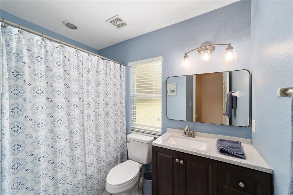 2151 Southeast 59th Street Ocala, FL 34480 - Photo 30 of 72 a bathroom with a double vanity sink toilet and a mirror