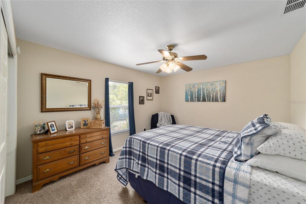 2151 Southeast 59th Street Ocala, FL 34480 - Photo 31 of 72 a bedroom with a bed and a chandelier