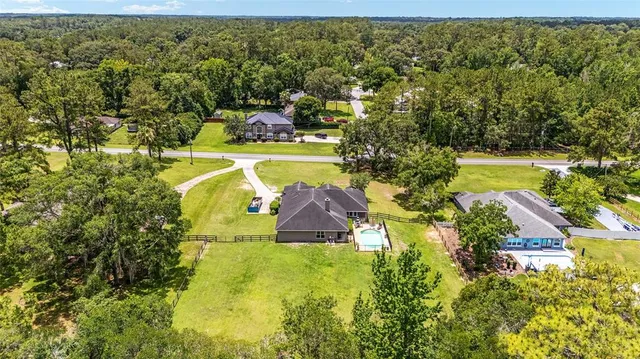 an aerial view of a house with a yard