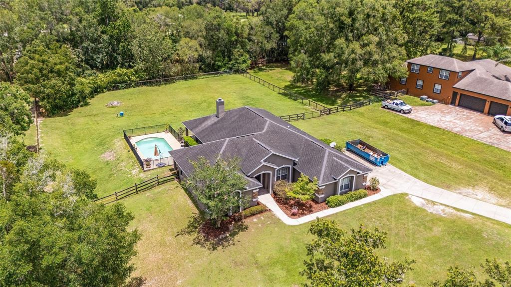 2151 Southeast 59th Street Ocala, FL 34480 - Photo 42 of 72 an aerial view of a house with swimming pool and large trees