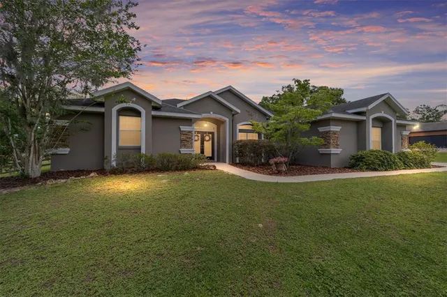 a view of a house with swimming pool and sitting area
