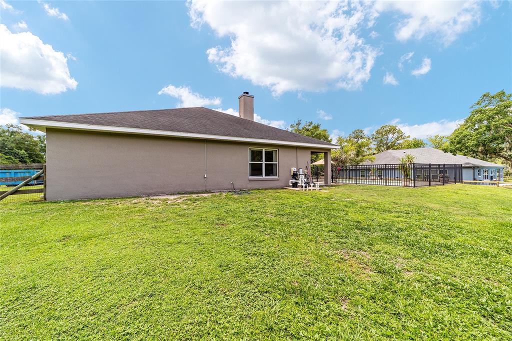 2151 Southeast 59th Street Ocala, FL 34480 - Photo 56 of 72 a front view of a house with garden