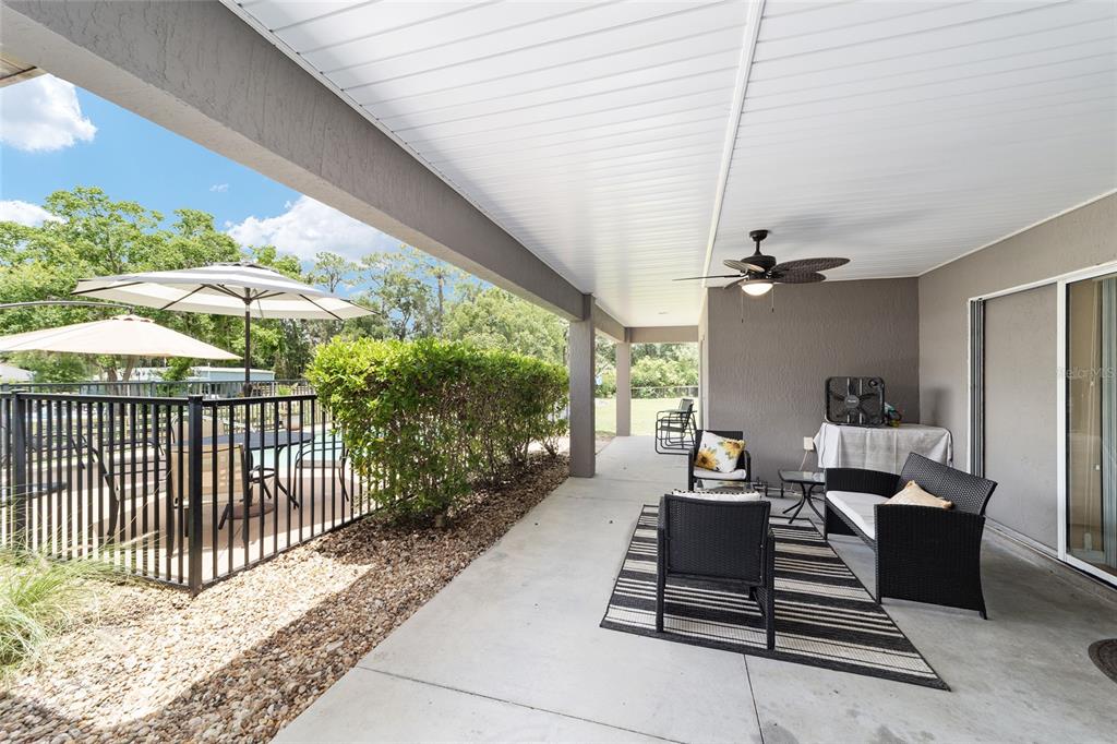 2151 Southeast 59th Street Ocala, FL 34480 - Photo 68 of 72 a living room with furniture and a floor to ceiling window