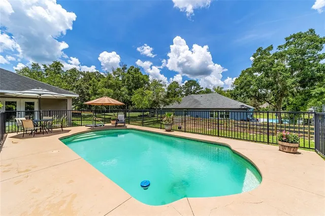 a view of a house with backyard sitting area and garden