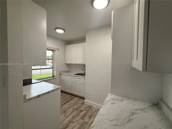 a kitchen with a refrigerator and a stove top oven