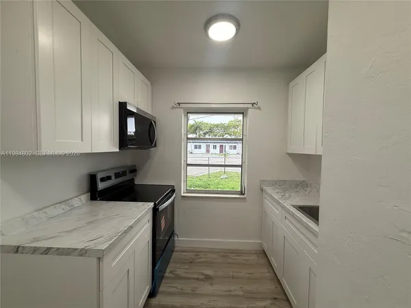 a kitchen with stainless steel appliances granite countertop a sink and a stove top oven