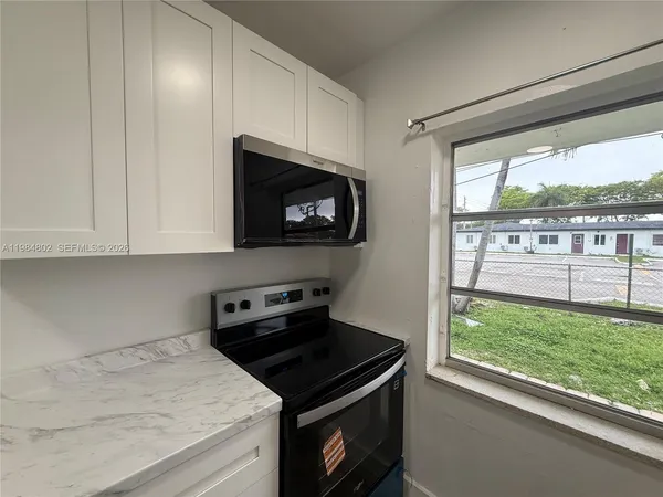 a kitchen with a stove and a microwave