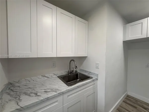 a kitchen with a sink and cabinets