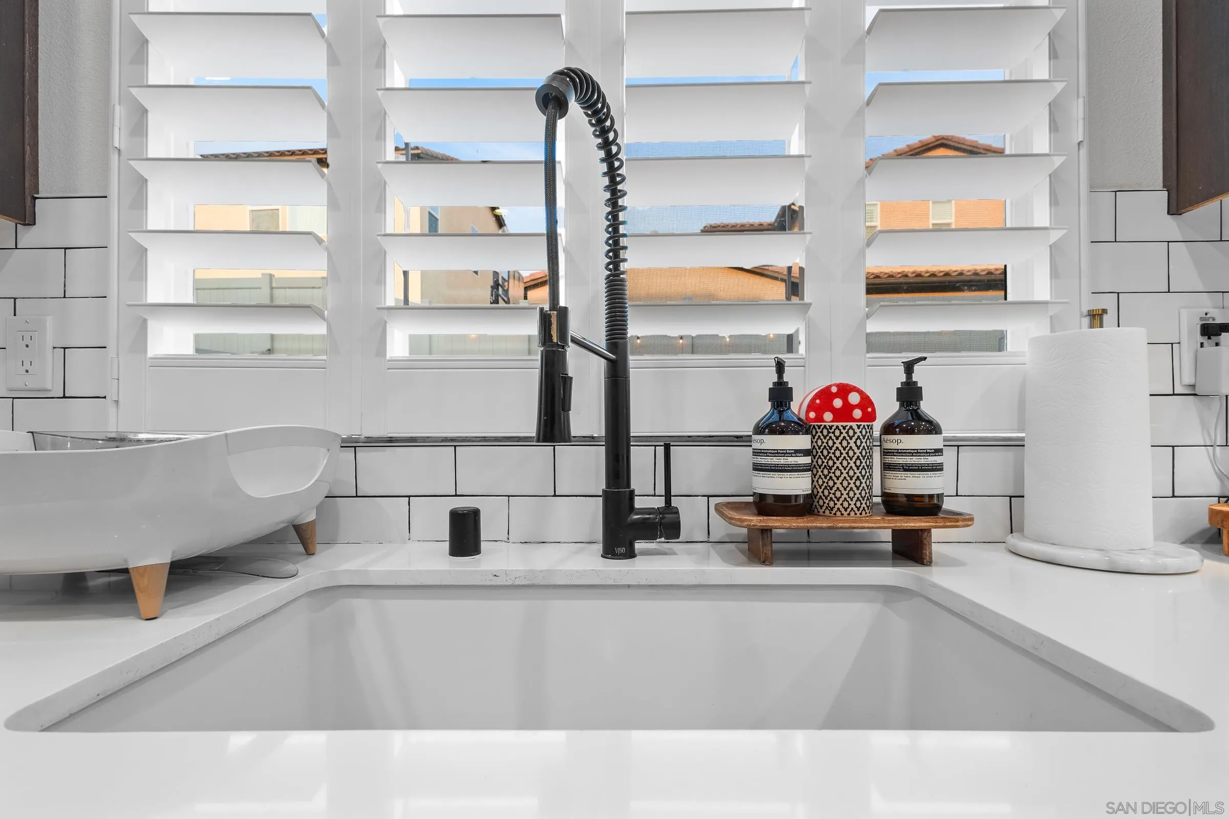 1853 Ashley Avenue Chula Vista, CA 91913 - Photo 13 of 73 a kitchen with a sink and a window with potted plants