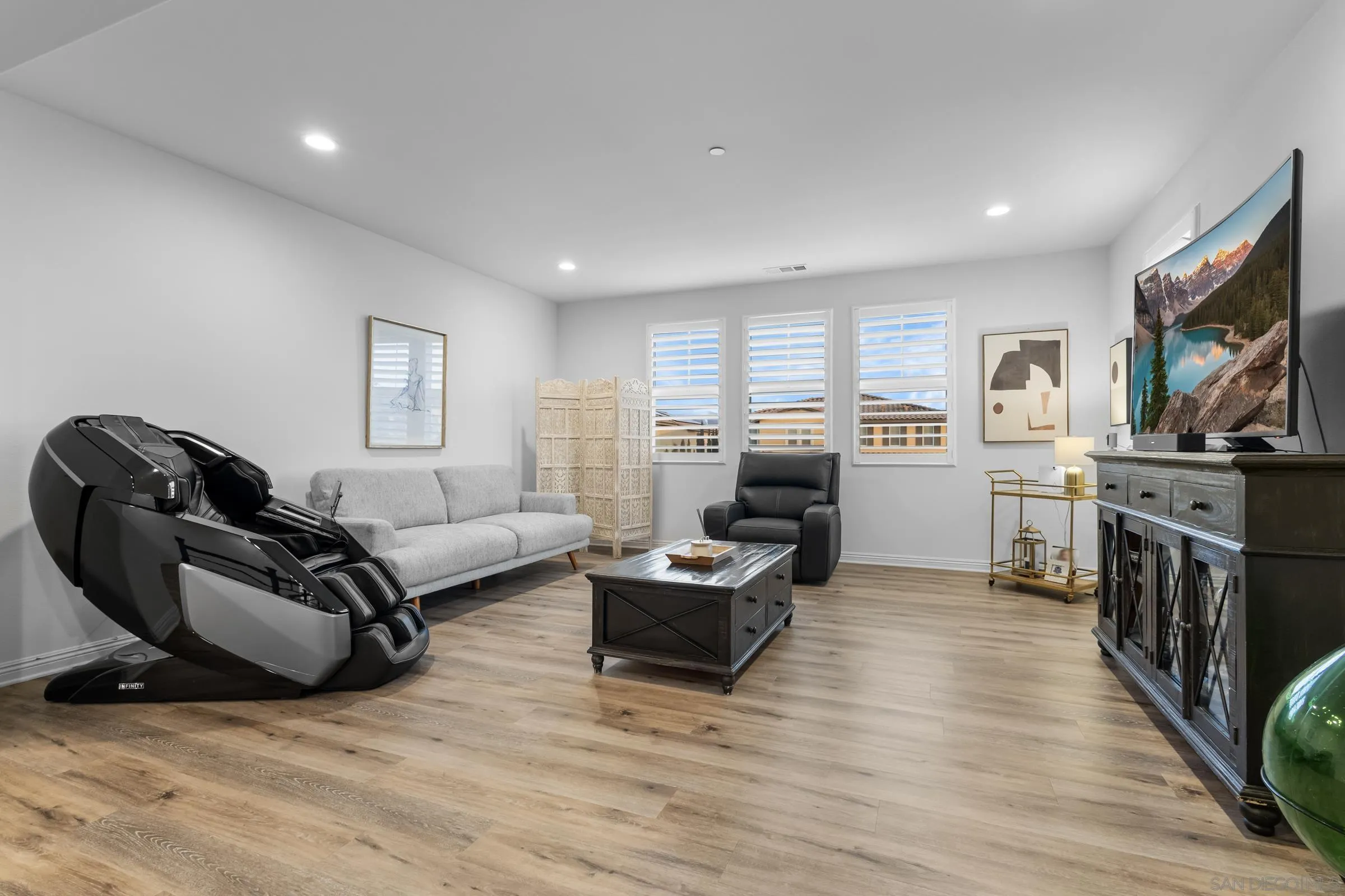 1853 Ashley Avenue Chula Vista, CA 91913 - Photo 18 of 73 a living room with furniture a flat screen tv and a wooden floor