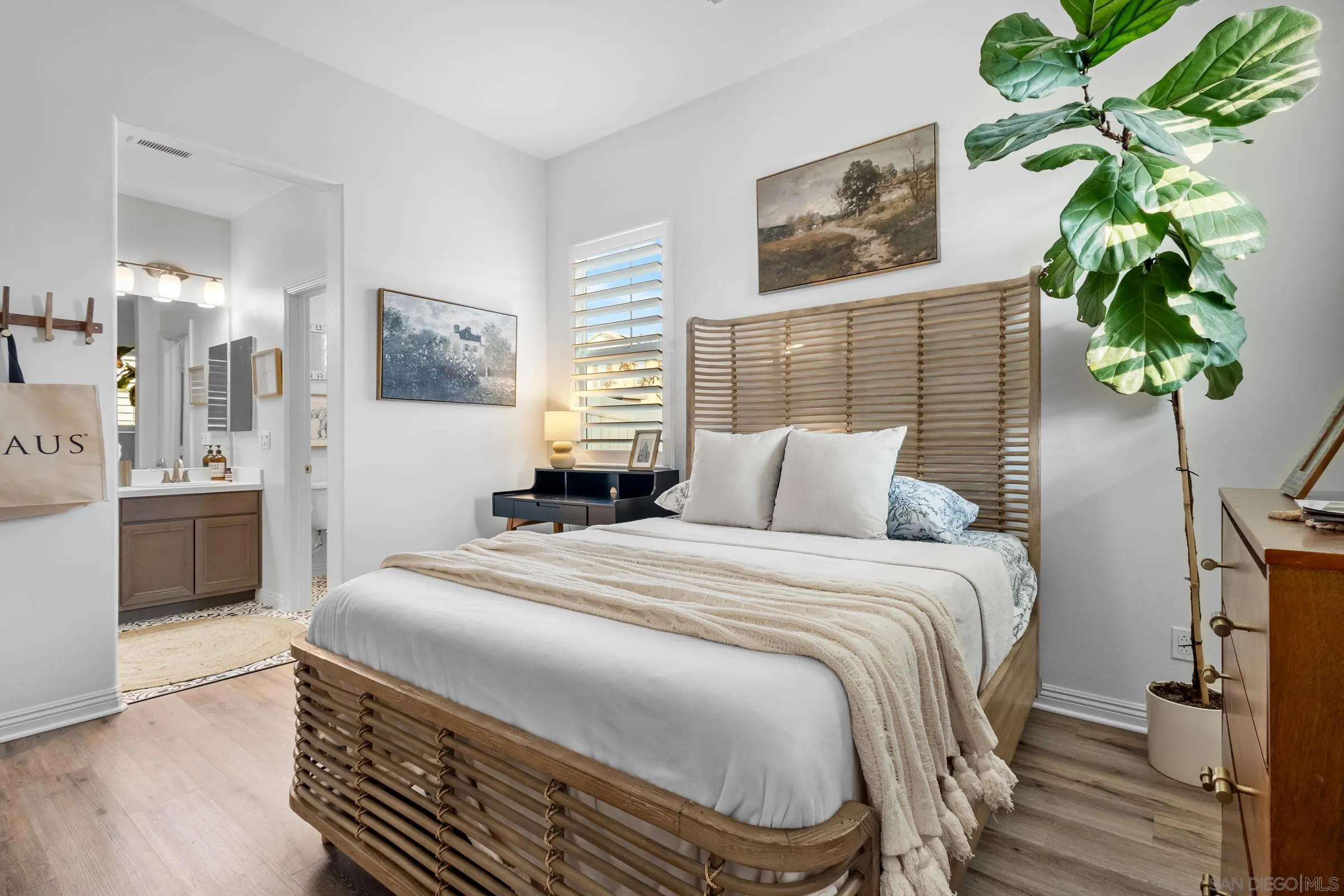 1853 Ashley Avenue Chula Vista, CA 91913 - Photo 23 of 73 a bedroom with a bed table and a potted plant