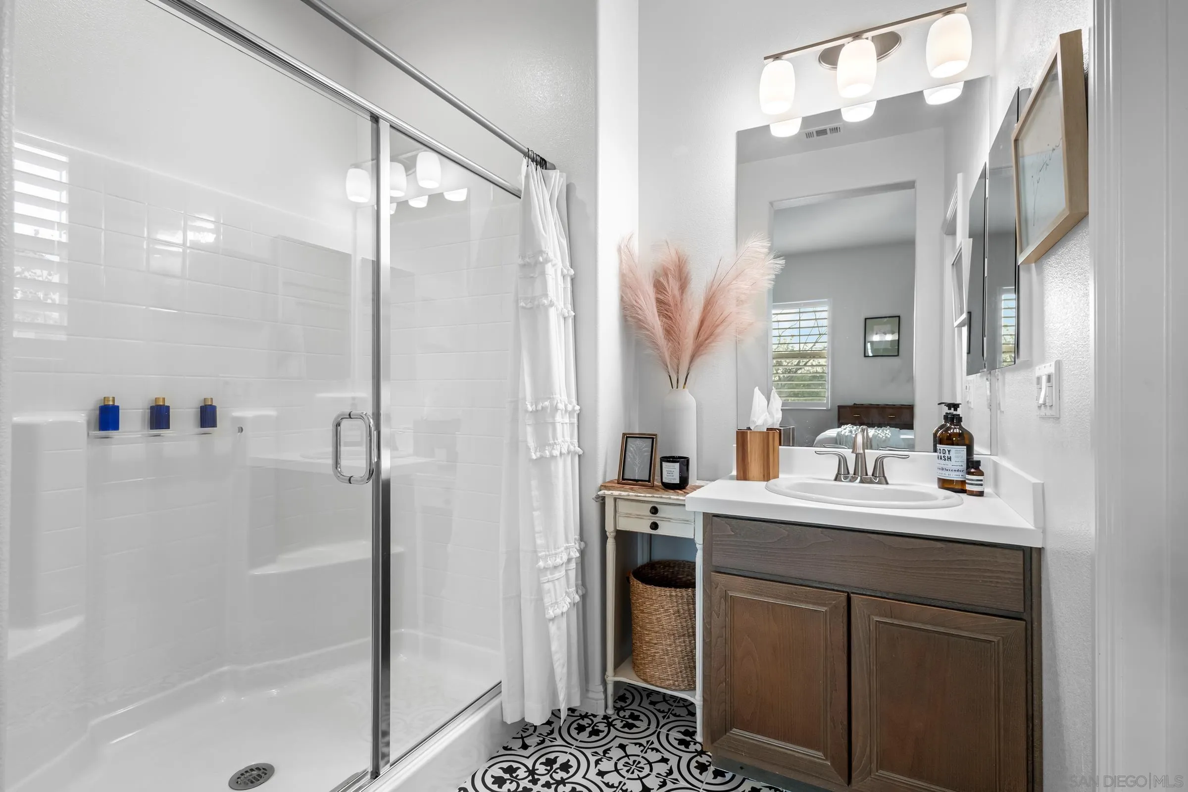 1853 Ashley Avenue Chula Vista, CA 91913 - Photo 24 of 73 a bathroom with a sink a mirror and a shower