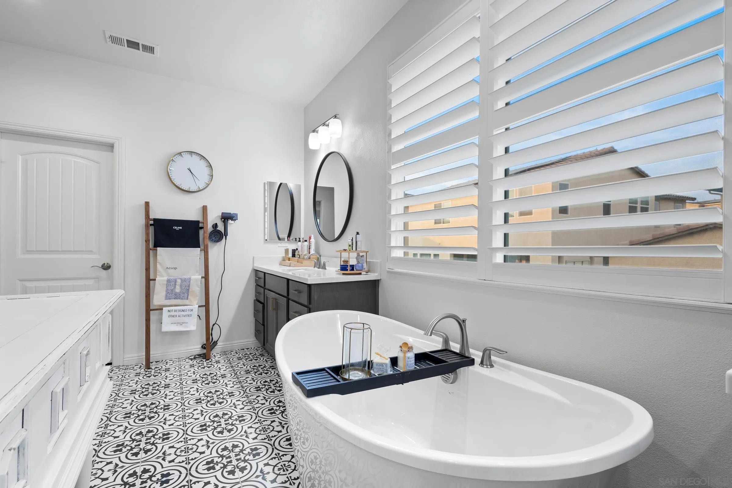 1853 Ashley Avenue Chula Vista, CA 91913 - Photo 32 of 73 a bathroom with a sink a mirror and a window
