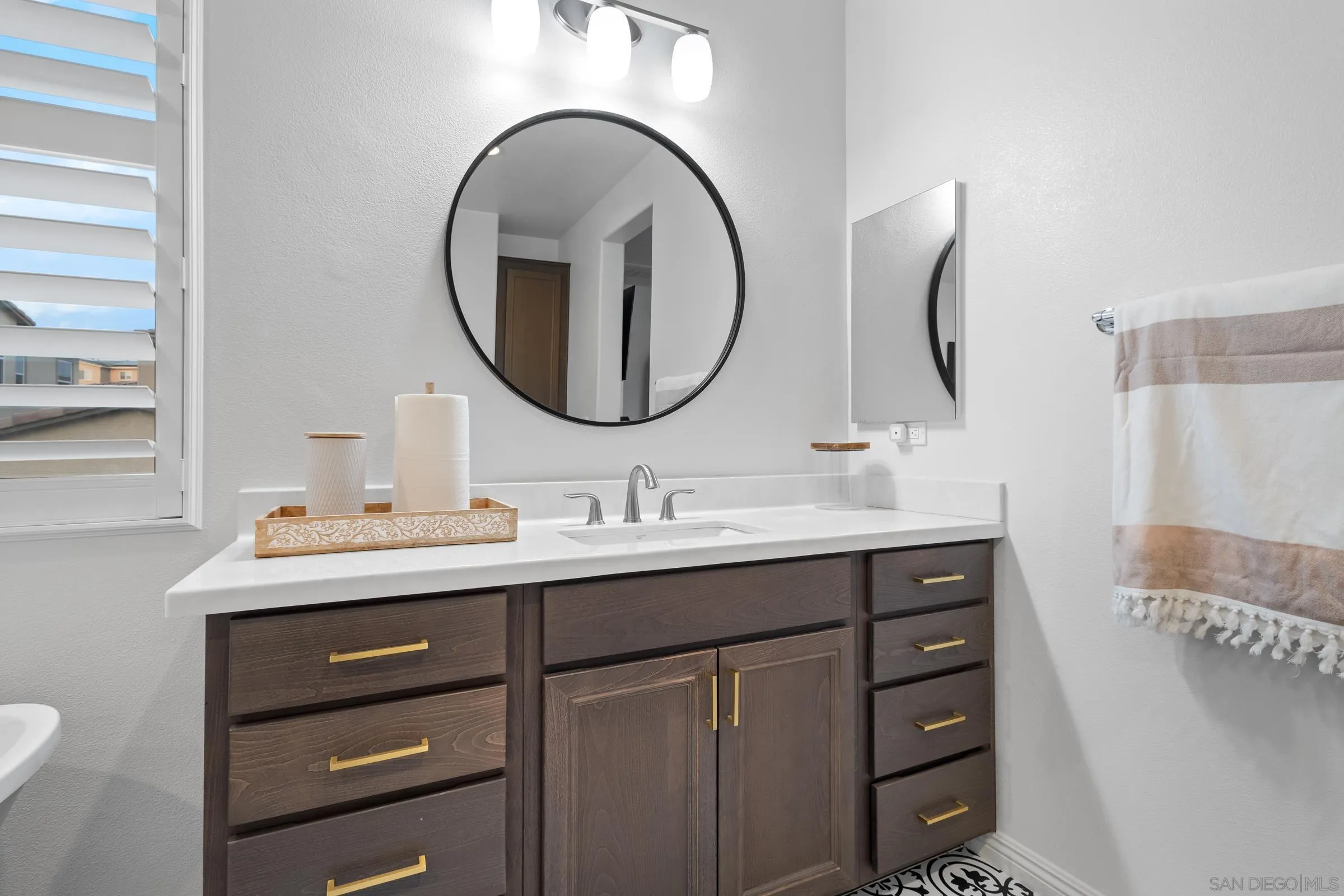 1853 Ashley Avenue Chula Vista, CA 91913 - Photo 36 of 73 a bathroom with a double vanity sink and a mirror