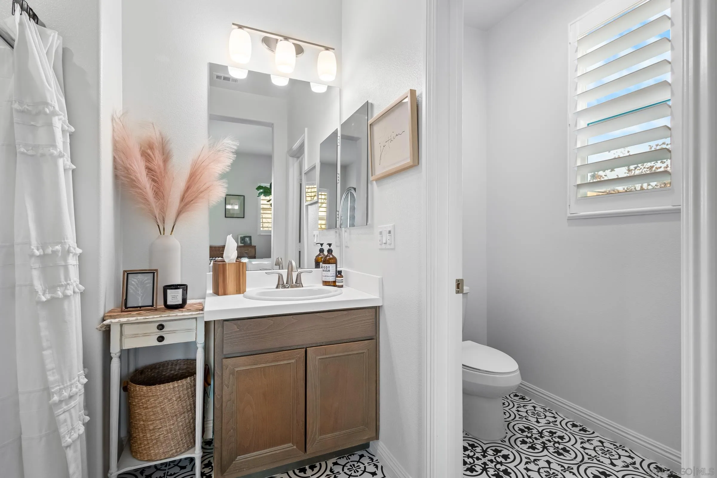 1853 Ashley Avenue Chula Vista, CA 91913 - Photo 37 of 73 a bathroom with a sink a toilet and a mirror