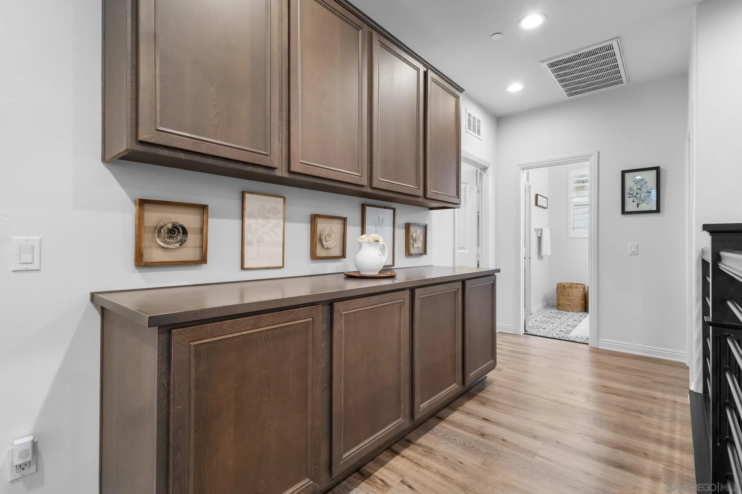 1853 Ashley Avenue Chula Vista, CA 91913 - Photo 42 of 73 a kitchen with stainless steel appliances granite countertop a sink and cabinets with wooden floor