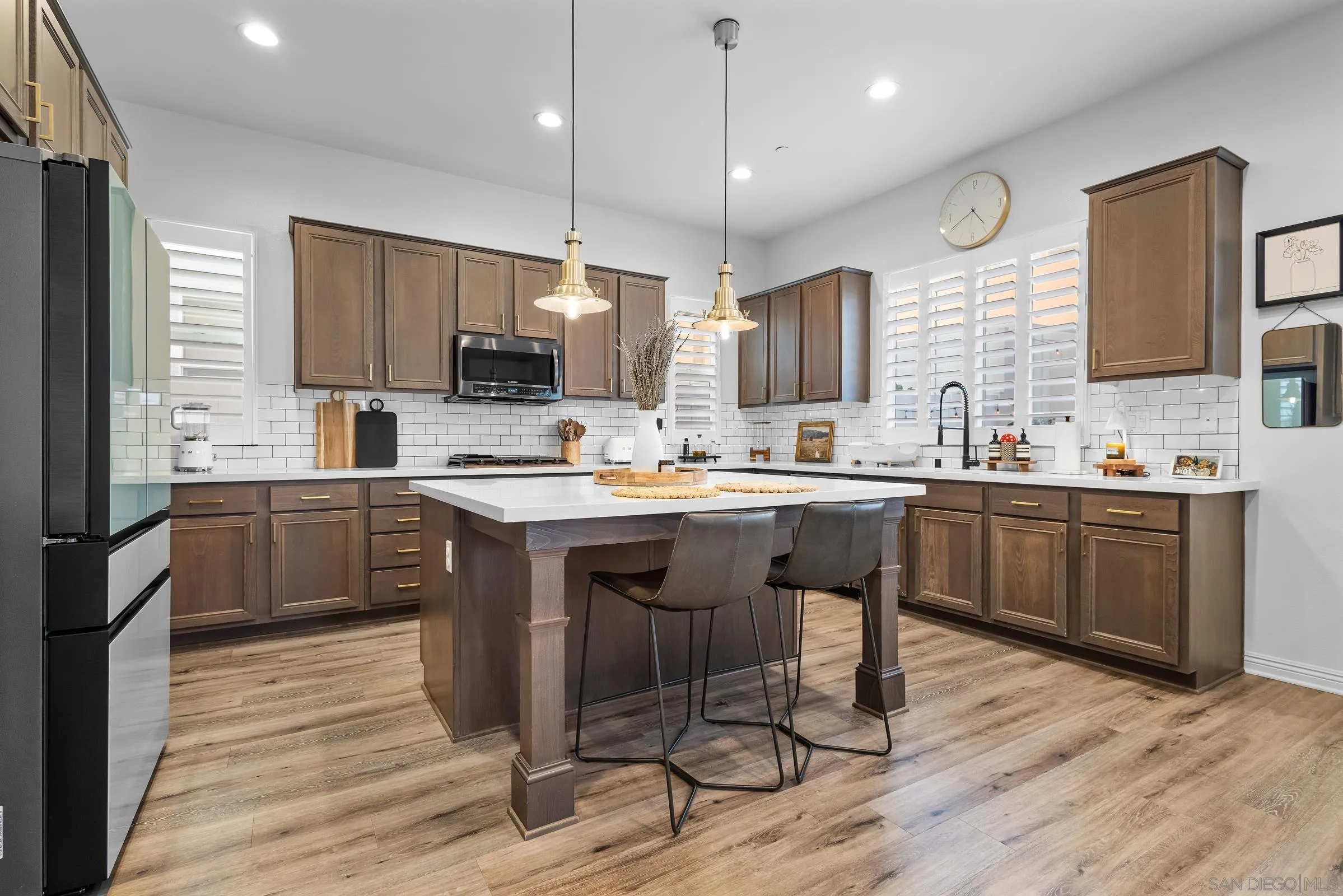 1853 Ashley Avenue Chula Vista, CA 91913 - Photo 10 of 73 a kitchen with a sink a counter top space stainless steel appliances and cabinets