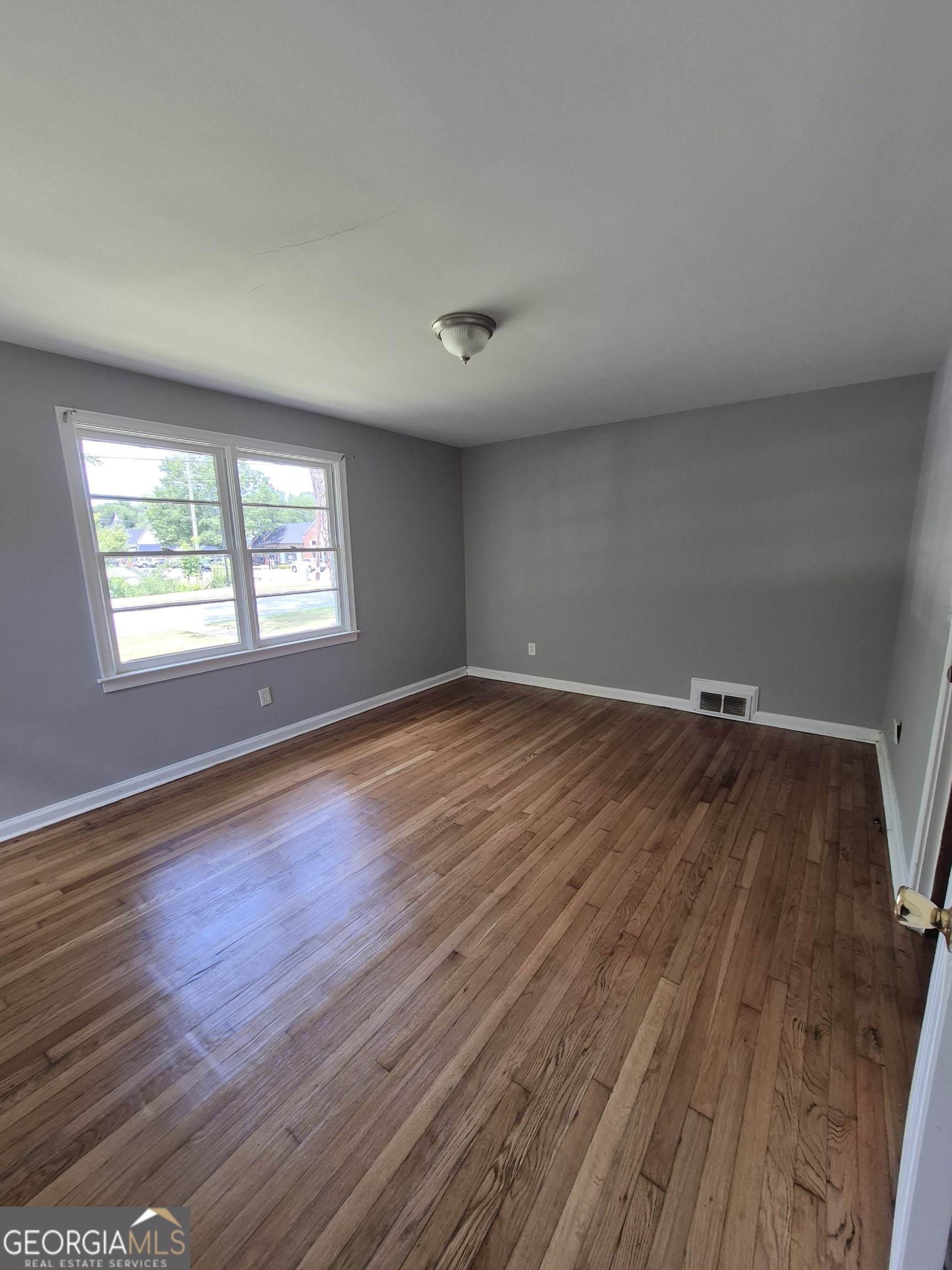 1908 Garrard Street Columbus, GA 31906 - Photo 12 of 14 an empty room with wooden floor and windows