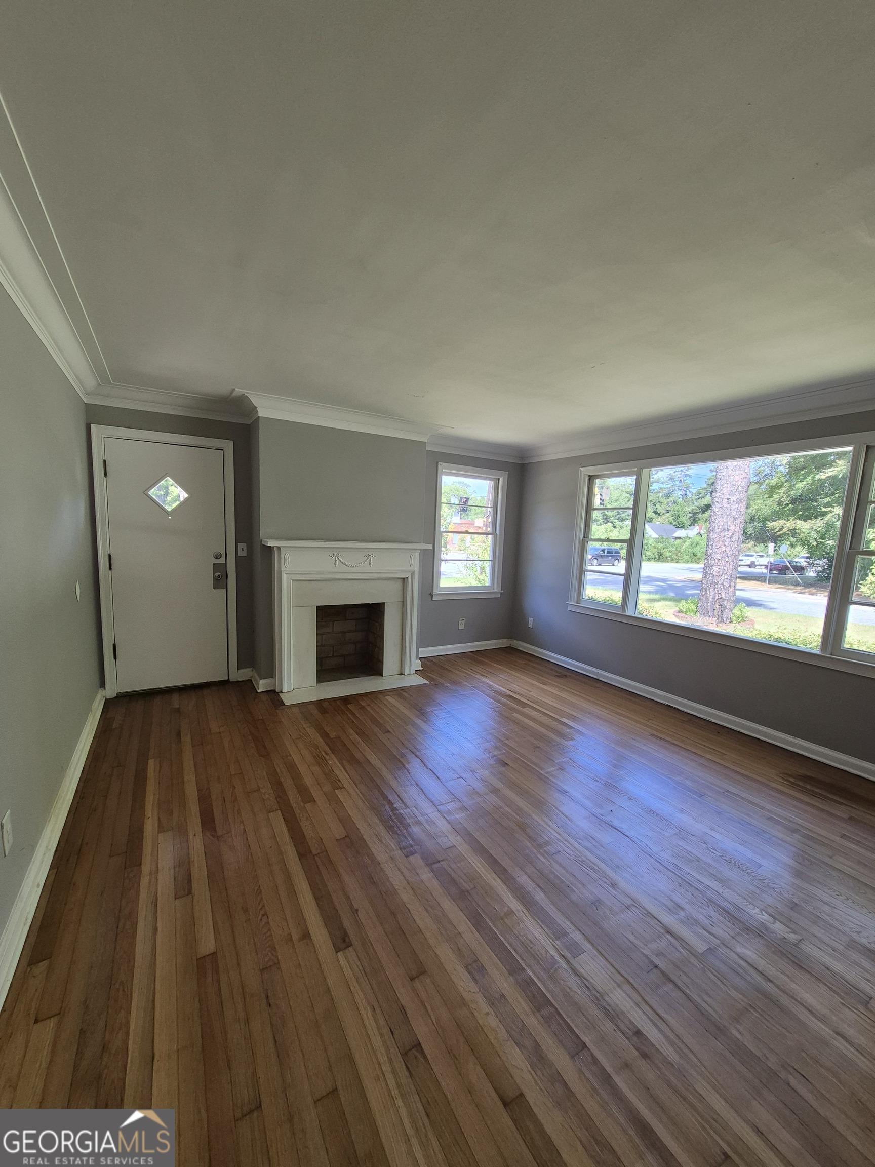 1908 Garrard Street Columbus, GA 31906 - Photo 6 of 14 a view of an empty room with wooden floor and a window
