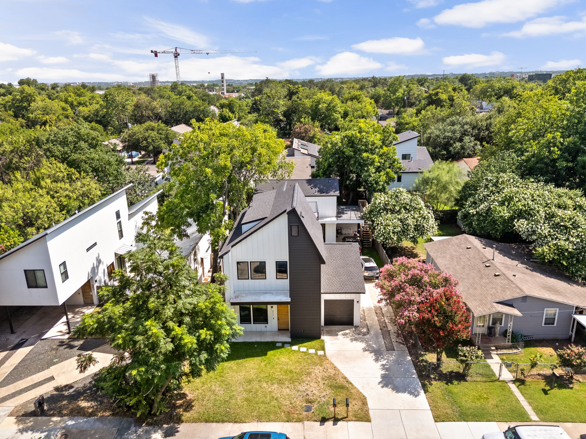 2717 Lyons Road, Unit 1 Austin, TX 78702 - Photo 37 of 40 An aerial perspective reveals a modern architectural home nestled amongst lush green trees.