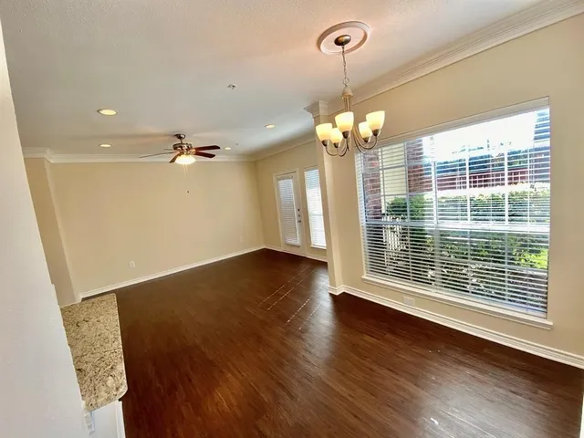 a view of a livingroom with a ceiling fan and window