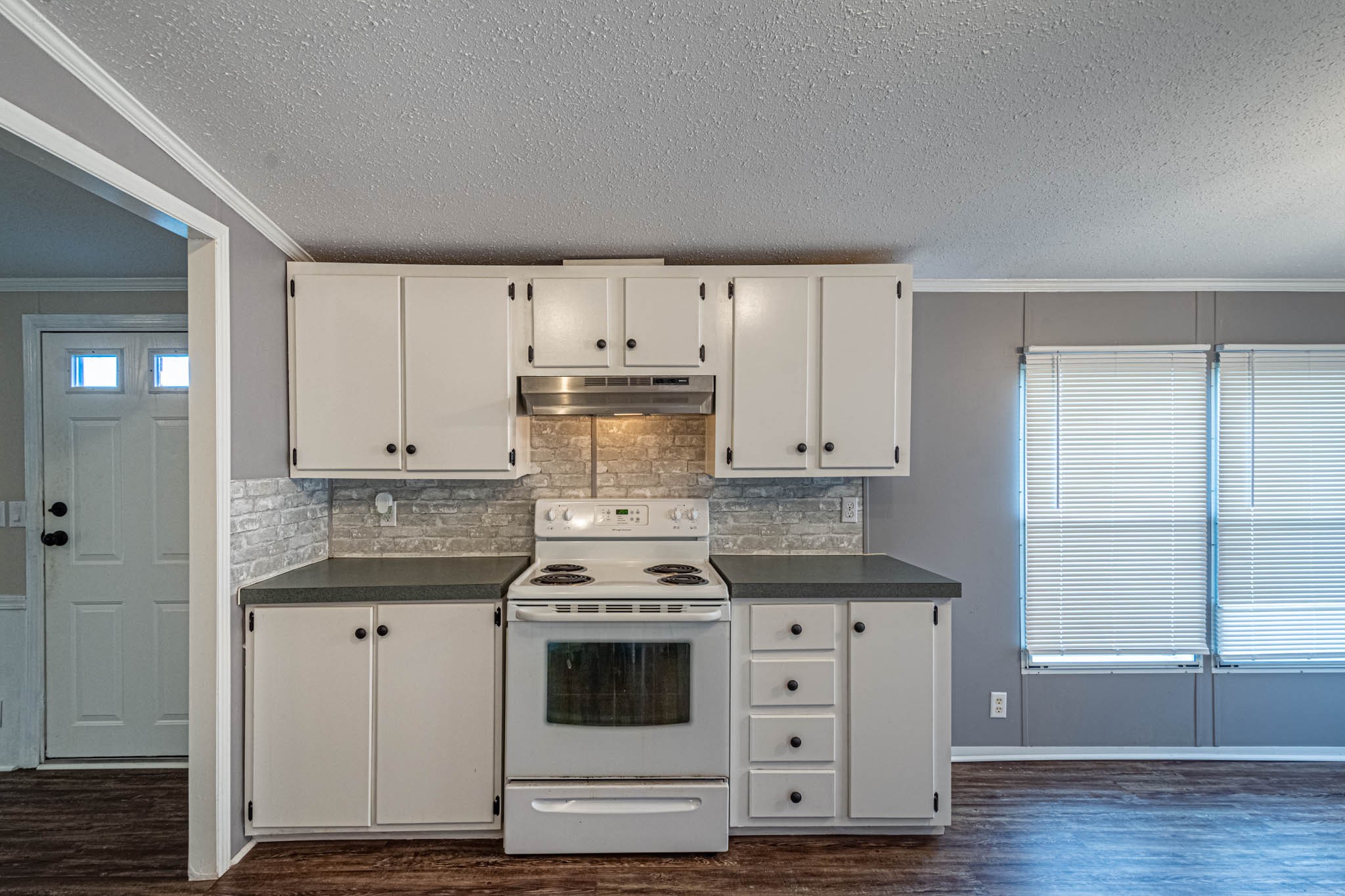 3375 Salem Road Minor Hill, TN 38473 - Photo 14 of 42 a kitchen with granite countertop white cabinets and white appliances