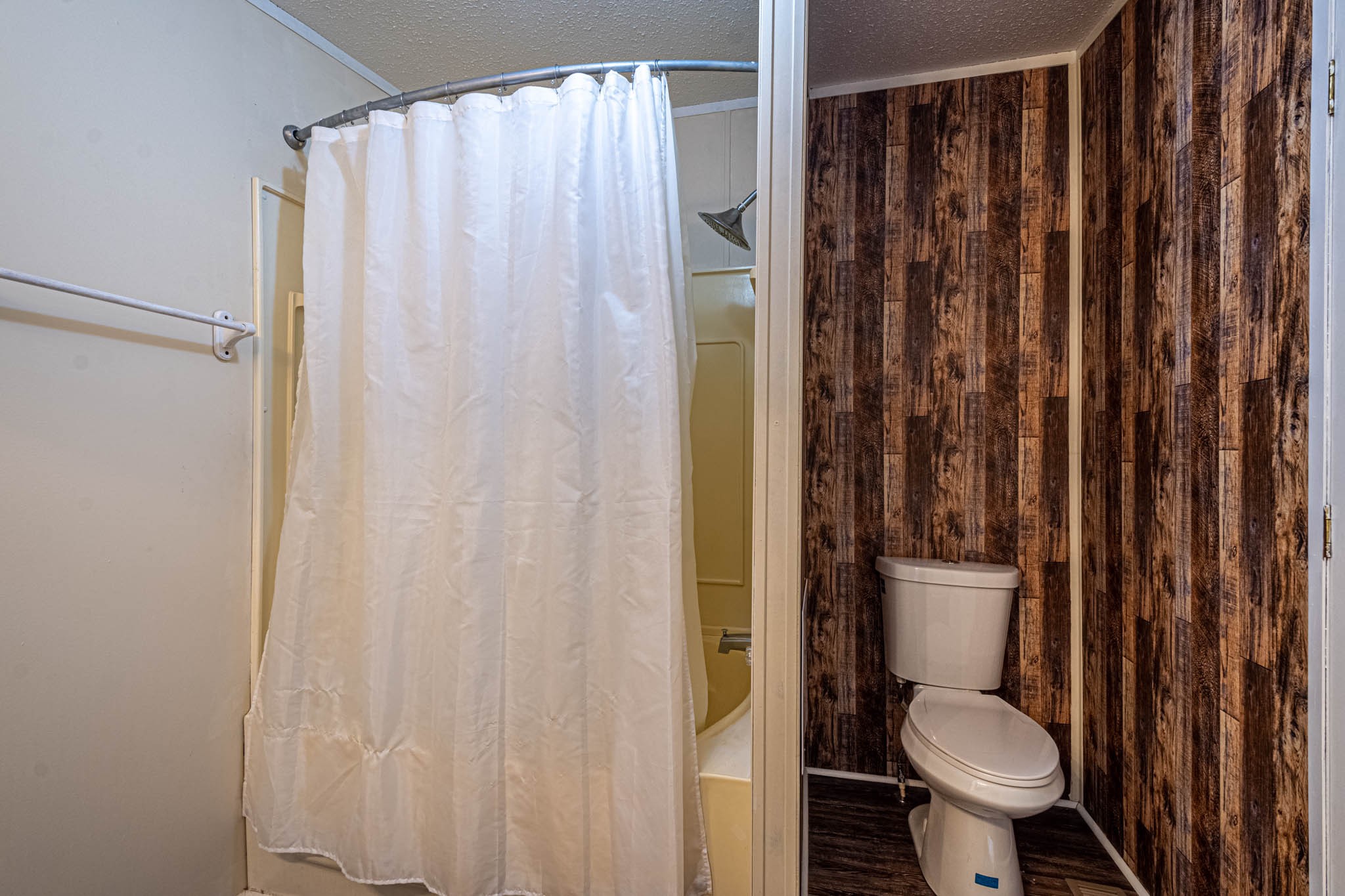 3375 Salem Road Minor Hill, TN 38473 - Photo 24 of 42 a bathroom with a toilet and a shower curtain