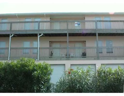 a view of backyard with seating space and wooden fence