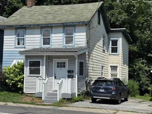 a front view of a house with parking space