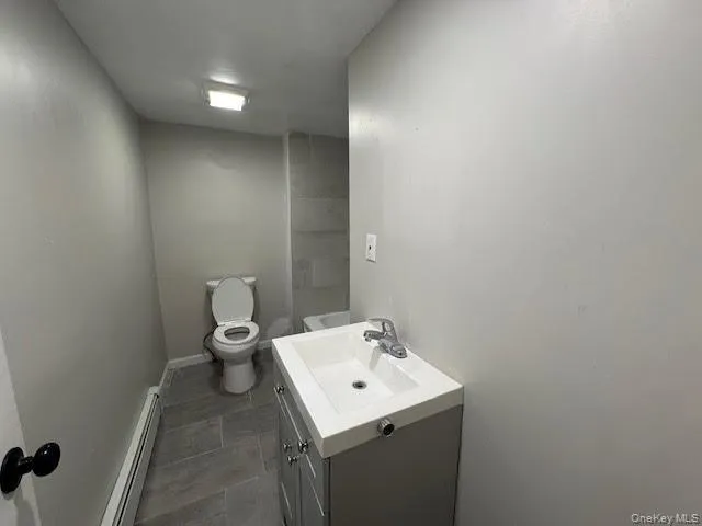 a bathroom with a sink toilet and mirror