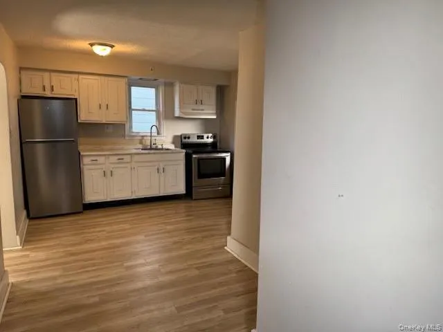 a kitchen with a refrigerator sink and stove