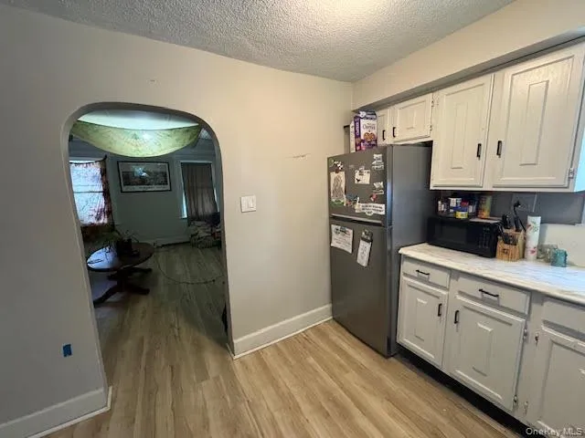 a kitchen with stainless steel appliances a stove refrigerator and cabinets